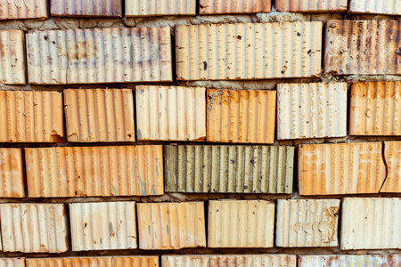 Close Up Of Bricklayers Hand Placing Brick On Wall. High quality photo