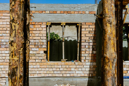 Single-family house construction site. Construction of a brick house with a wooden roof truss. High...