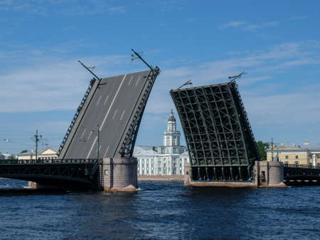 26 of July 2020 - St. Peterburg, Russia. Drawbridge in St. Petersburg. The Kunstkamera building between the openings of the bridge.のeditorial素材