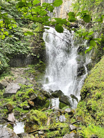 Mountain waterfall flowing among rocks in a narrow gorge