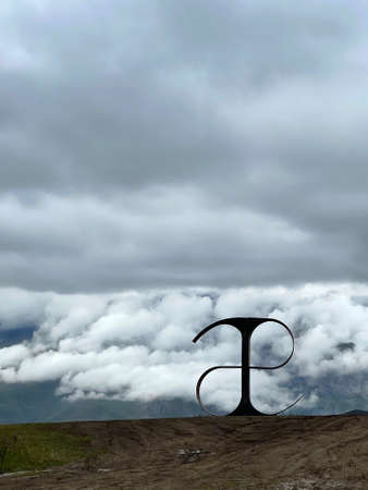 24 of July 2021 - Norht Ossetia, Russia: The first letter of the Ossetian alphabet in the Caucasus Mountains Against the background of clouds, Caucasusのeditorial素材