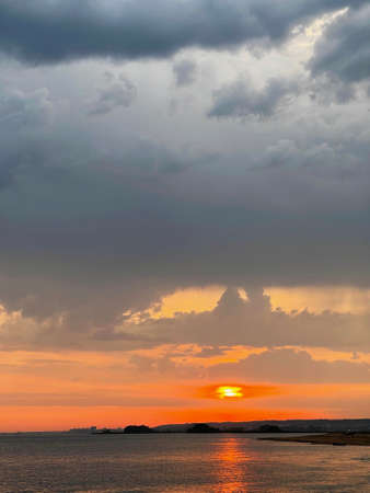 Colorful sunset on the dramatic sky over the Volga river near Kazan, Russia. The solar disk enters...
