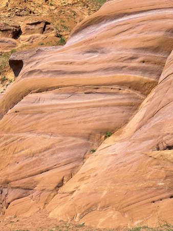 Uneven rough wall of red rock, part of the canyon in Kukmor, Tatarstan, Russiaの写真素材