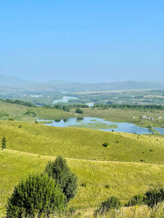 Lake and river Katun in the foothills of Altai on a sunny summer day, Russia