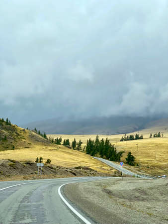Asphalt road in the Altai mountains. The road stretching into the distance in a mountain. A part of the Chuisky tract, Altai, Russiaの写真素材