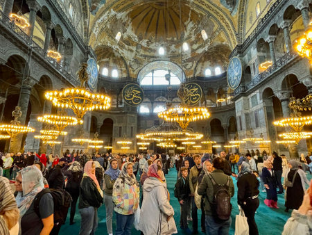 16 of April 2023 - Istanbul, Turkey: Interior decoration of Hagia Sofia, beautiful chandeliers, frescoes and crowdのeditorial素材