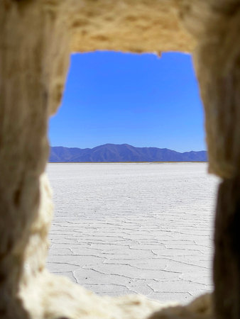 View of the salt marsh through the window of a house made of salt blocks. Salinas Grandes, Jujuy...