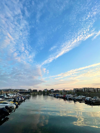 Pier for boats and motorboats on Volga river in the suburbs of Kazan at sunset, Russiaの写真素材