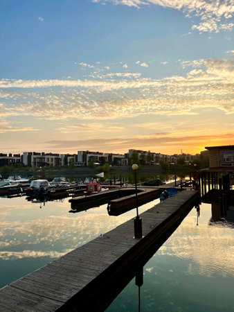 Pier for boats and motorboats on Volga river in the suburbs of Kazan at sunset, Russiaの写真素材