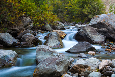 Stony bottom of the mountain river. Cascade waterfalls. Altai Mountains, Russia