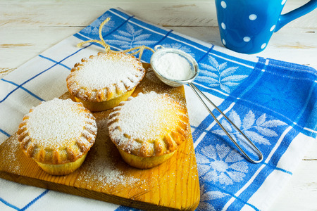 Small confiture pie and custer sugar in sieve for a bakingの写真素材