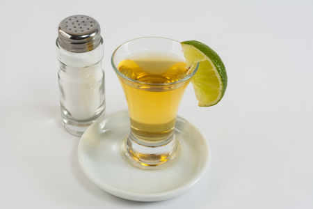 Tequila with lime on the white background. Tequila shot. Gold Mexican tequila. Tequilaの写真素材