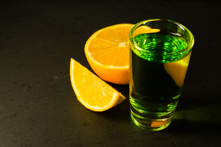 Absinthe on black background. Alcohol drink.