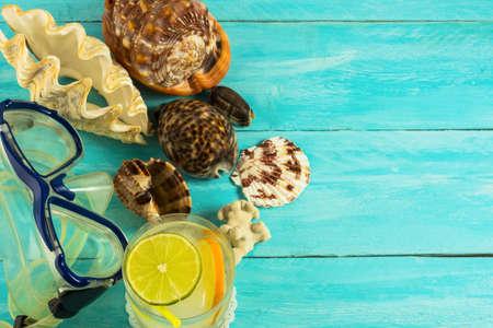 Seashells and beach cocktail background. Beach cocktail. Beach party.  Beach drink. Tropical relax.の写真素材