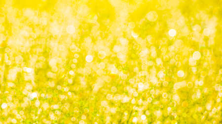 Yellow bokeh defocused background. Yellow bokeh blurred texture.の写真素材