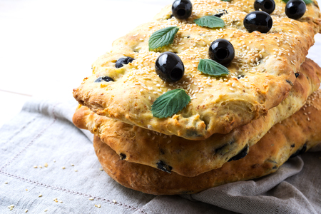 Stack of traditional Italian bread focaccia on the linen napkin. Homemade traditional Italian bread focaccia.の写真素材