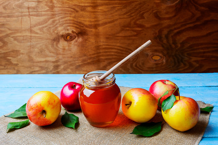 Honey glass jar and apples on rustic background copy space. Rosh hashanah concept. Jewesh new year symbols.の写真素材