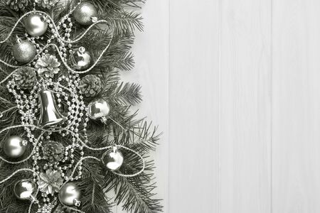 Christmas background with silver ornaments, copy space, toned. Christmas decoration with fir branches and glass beads.の写真素材