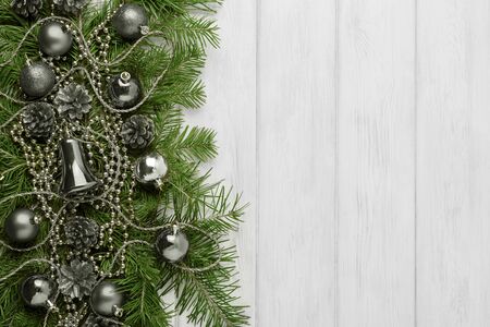 Christmas background with silver ornaments, copy space. Christmas decoration with fir branches and glass beads.の写真素材
