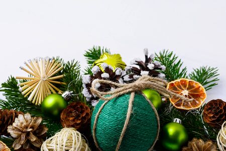 Christmas decoration with handmade twine decorated bauble. Christmas background with fir branches and  homemade rustic ornaments. Copy space.の写真素材