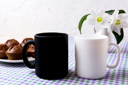 White and black mug mockup with chocolate muffins.  Empty mug mock up for design presentation.の写真素材