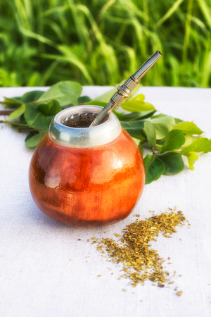 Traditional Latin America herbal tea in mate calabash with special straw bombillaの写真素材