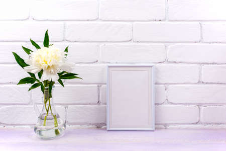 White small frame mockup with cream peony in the glass pitcher vase. Empty frame mock up for...