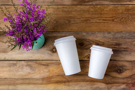 White coffee disposable hot paper cup with lid mockup with purple wildflowers. Plastic coffee cups...