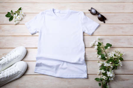 White womens cotton T-shirt mockup with sneakers, sunglasses and apple blossom. Design t shirt template, tee print presentation mock upの写真素材