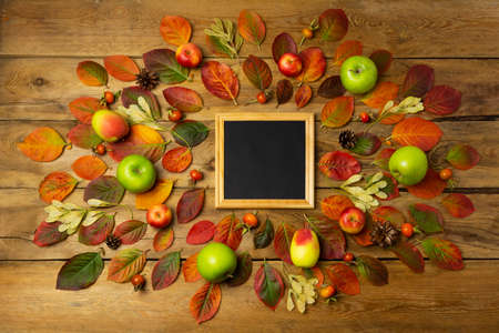 Black chalkboard wooden square frame rustic mockup with fall leaves. Empty blackboard frame mock up for presentation design. Template black felt letter board framing for modern art.の写真素材