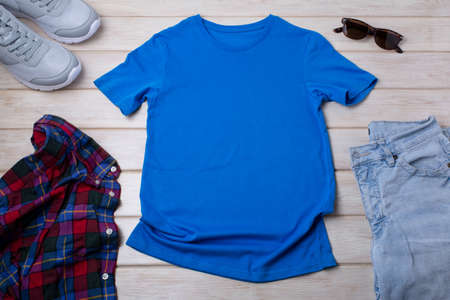 Blue unisex cotton T-shirt mockup with gray trainers and jeans. Design t shirt template, tee print presentation mock upの写真素材