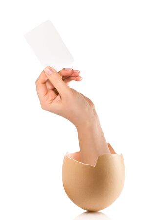 Hand with broken egg isolated on white backroundの写真素材