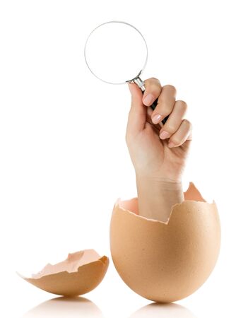 Hand with broken egg isolated on white backroundの写真素材