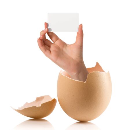 Hand with broken egg isolated on white backroundの写真素材