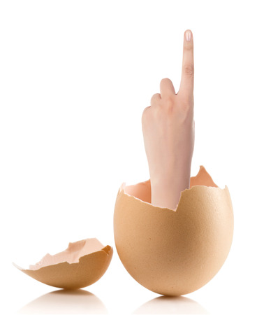 Hand with broken egg isolated on white backroundの写真素材