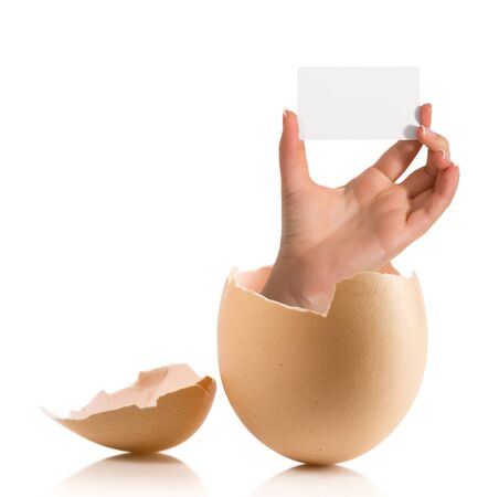 Hand with broken egg isolated on white backroundの写真素材