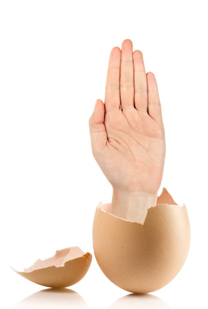 Hand with broken egg isolated on white backroundの写真素材