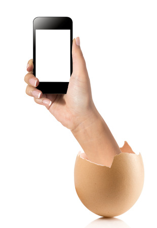 Hand with broken egg isolated on white backround. Hand of young man holding smart phone white screen isolated on white background with clipping pathの写真素材