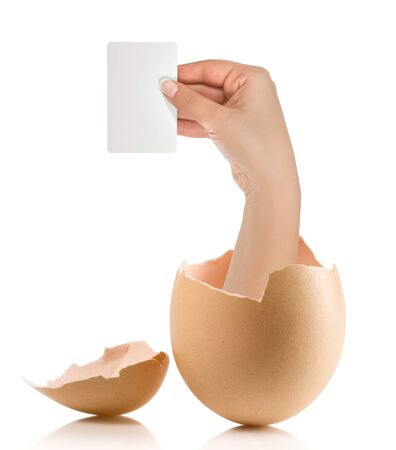 Hand with broken egg isolated on white backroundの写真素材