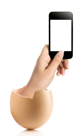 Hand with broken egg isolated on white backround. Hand of young man holding smart phone white screen isolated on white background with clipping pathの写真素材