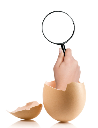 Hand with broken egg isolated on white backroundの写真素材