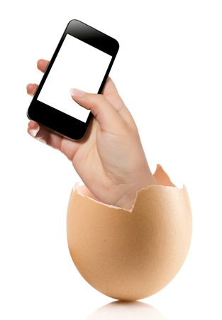 Hand with broken egg isolated on white backround. Hand of young man holding smart phone white screen isolated on white background with clipping pathの写真素材