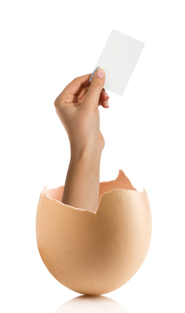 Hand with broken egg isolated on white backroundの写真素材