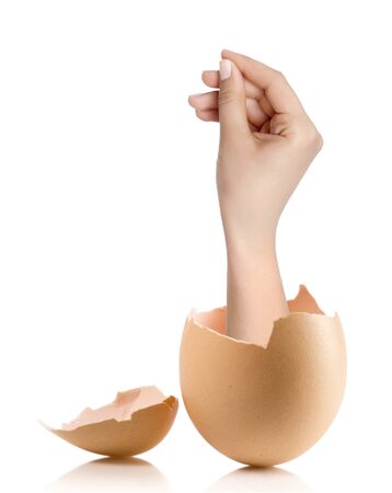 Hand with broken egg isolated on white backroundの写真素材