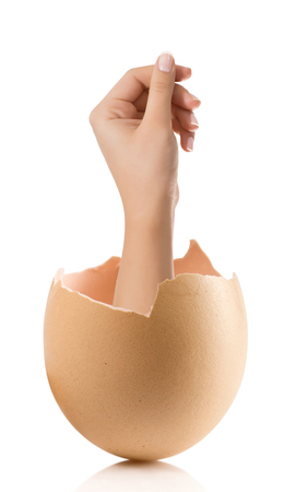 Hand with broken egg isolated on white backroundの写真素材