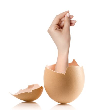 Hand with broken egg isolated on white backroundの写真素材
