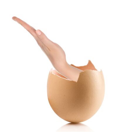 Hand with broken egg isolated on white backroundの写真素材