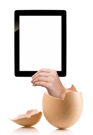 Hand holding a tablet computer with white screen. Hand with broken egg isolated on white backround. Hand holding tablet pc isolated on white background with blank screen.の写真素材