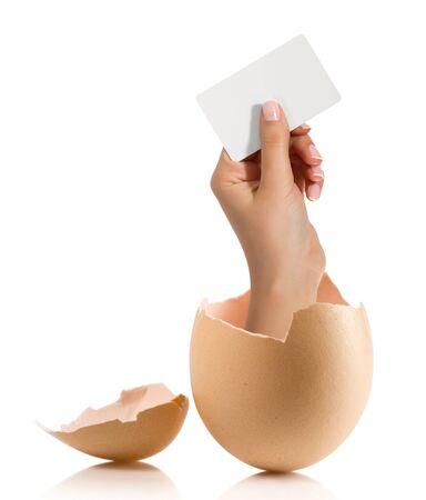 Hand with broken egg isolated on white backroundの写真素材
