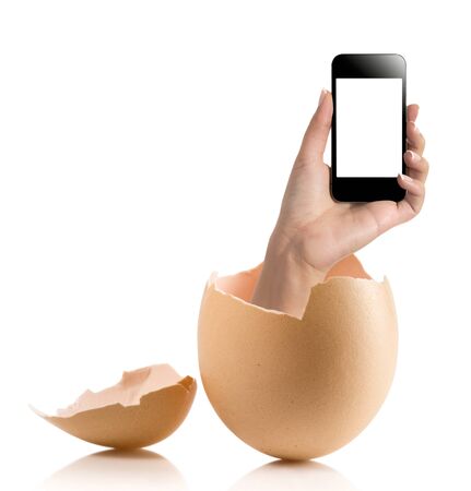 Hand with broken egg isolated on white backround. Hand of young man holding smart phone white screen isolated on white background with clipping pathの写真素材